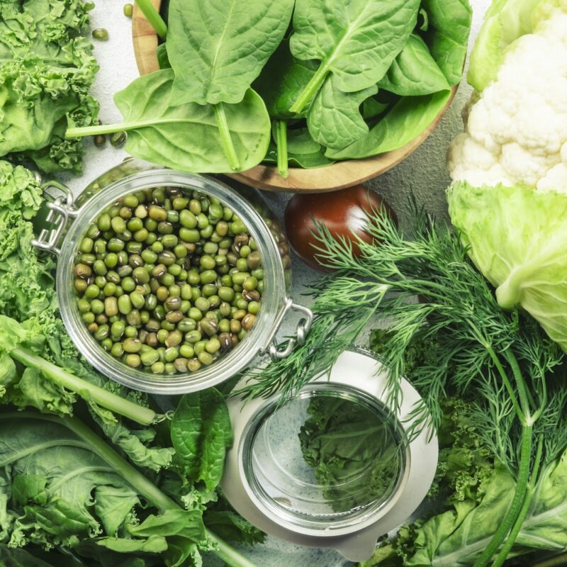 Green vegetables, herbs, beans and fruits. Healthy clean eating: leaf vegetables, seeds, superfoods